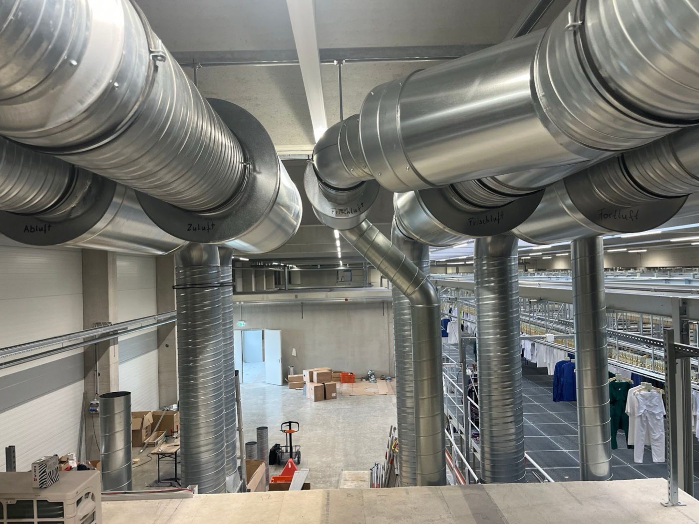 Große Lüftungsrohre unter der Hallendecke eines Gewerbebaus